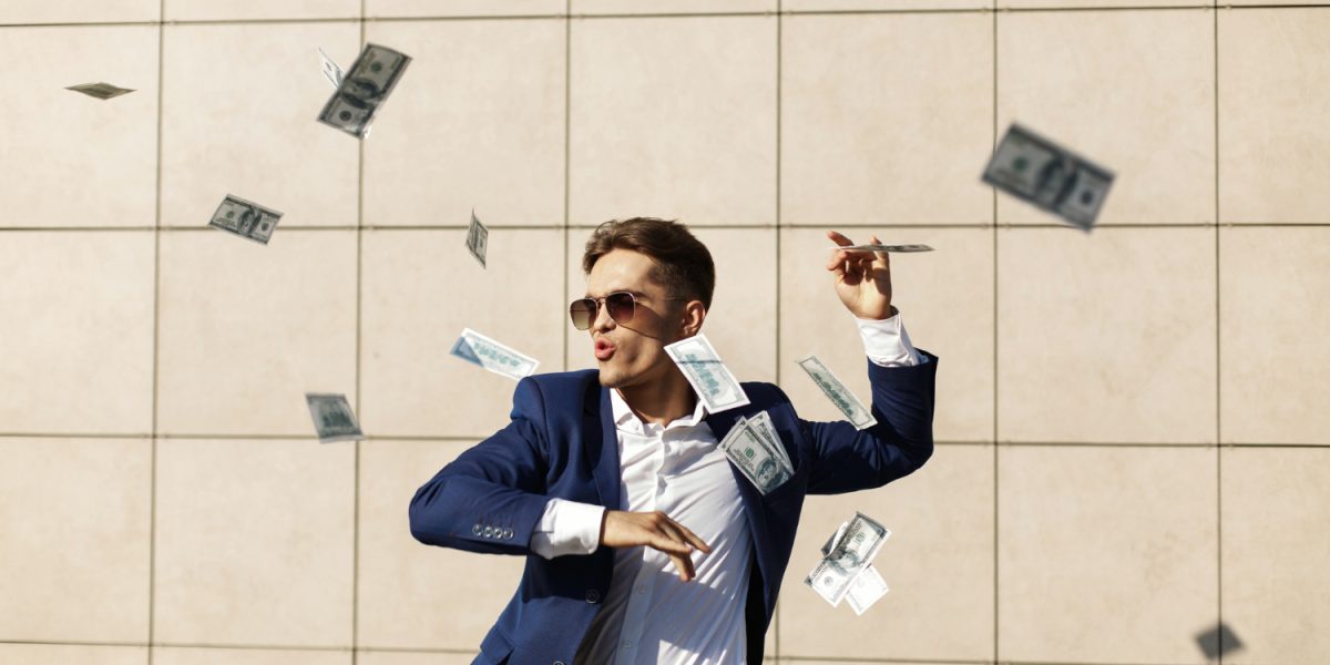 young-businessman-throughs-around-dollars-and-dances-on-the-street young-businessman-throughs-around-dollars-and-dances-on-the-street